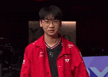 a man wearing glasses and a red shirt with the number 11 on it