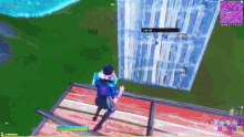a person is playing a video game while standing on a ledge .