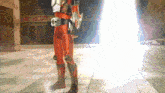 a man in a red costume is standing in front of a building with a sign that says ' a ' on it