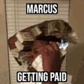 a man is carrying a large stack of money on his head .