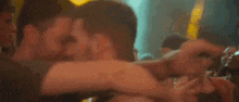 a man with a mustache is dancing in front of a crowd of people at a party .