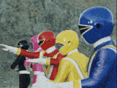 a group of power rangers are standing in a row with their arms outstretched