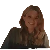 a woman wearing a sweatshirt that says phlct smiles