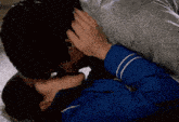 a man and woman are kissing on a bed .