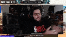 a man wearing a chicago bulls shirt is on a video screen