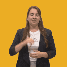 a woman wearing a shirt that says eversa holds her hand to her head