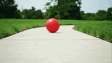 a red ball on a sidewalk with the word veo on the bottom right