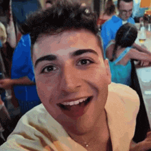 a young man is smiling with his tongue out in front of a crowd