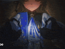 a girl is holding a book with the letters oe visible in the corner