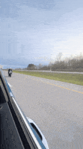 a person riding a motorcycle down a road