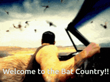 a man is driving a car with the words welcome to the bat country