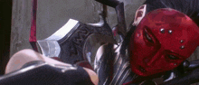 a woman with a red mask on her face is holding a large sword .