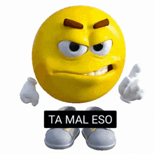 a yellow smiley face with a black sign that says ta mal eso