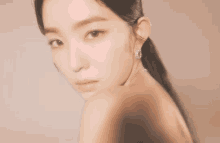 a close up of a woman 's face with a ponytail