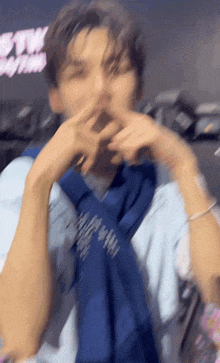 a blurry picture of a man covering his mouth with his hands