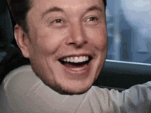 a close up of a man 's face with a smile on it
