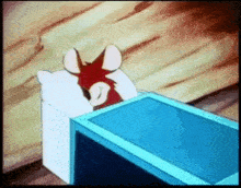 a cartoon mouse is laying in bed with a pillow