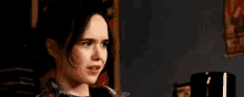 a young woman is making a funny face with her mouth open .