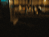 a blurry photo of a group of people dancing in front of a building that has the number 11 on it