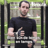 a man wearing a black shirt and gloves says " bien sur de temps en temps "