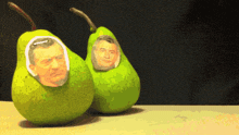 two green pears with a picture of a man on them