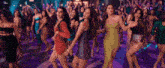 a group of women are dancing on a dance floor in a club .