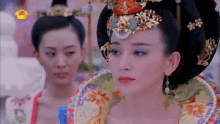 a woman in a traditional costume is looking at another woman
