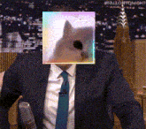 a man in a suit has a picture of a cat in front of his face
