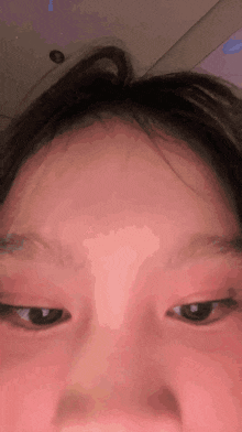 a close up of a person 's face with their eyes closed and their hair visible .