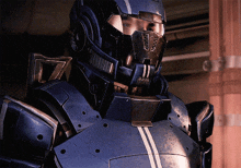 a close up of a person wearing a helmet and armor with the letter u on it