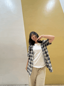 a girl wearing a plaid shirt and a white shirt