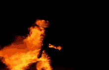 a large fire with smoke coming out of it is against a black background