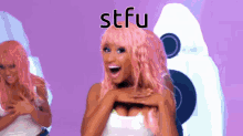 a woman with pink hair is standing in front of a purple background that says stfu