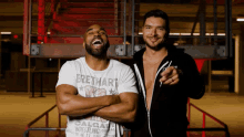 two men standing next to each other one wearing a calgary wrestling t-shirt