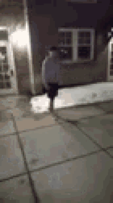 a blurry picture of a person standing in front of a building .