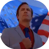 a man in a suit and tie stands in front of a large american flag
