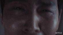 a close up of a man 's face with netflix written on the bottom right