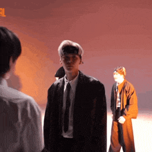 a man in a suit and tie is talking to another man in a white shirt
