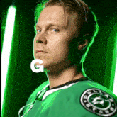 a man wearing a green jersey with the letter g on his neck
