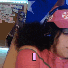 a woman wearing a pink hat with a candy cane on it and headphones