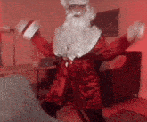 a man dressed in a santa claus costume is dancing in a living room