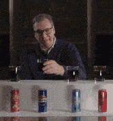 a man sitting at a table with a can of pepsi