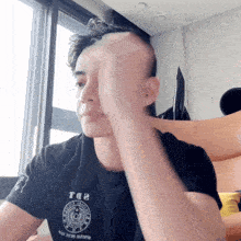 a man wearing a t-shirt that says t.p.d. on it