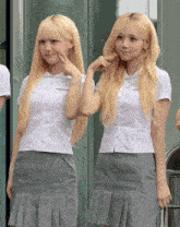 two girls with blonde hair are making funny faces