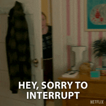 a netflix advertisement shows a woman peeking out from behind a door and says hey sorry to interrupt