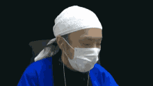 a man wearing a bandana and a face mask has earbuds in his ears