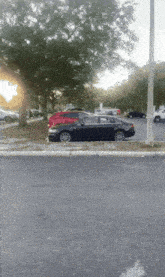 a black car is parked in a parking lot