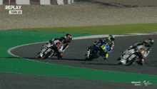a man riding a motorcycle on a track with the words replay on the top