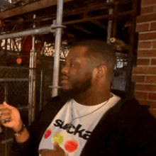 a man wearing a t-shirt that says sucka