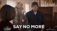 a man is giving a high five to a woman in a hallmark movie .